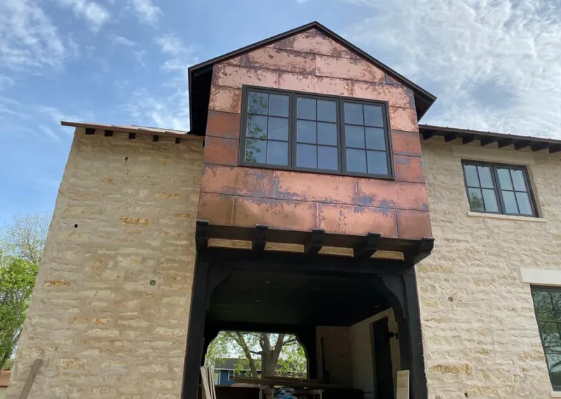 Copper metal panel facade on a stone building for Skylight Installation in Grand Blanc